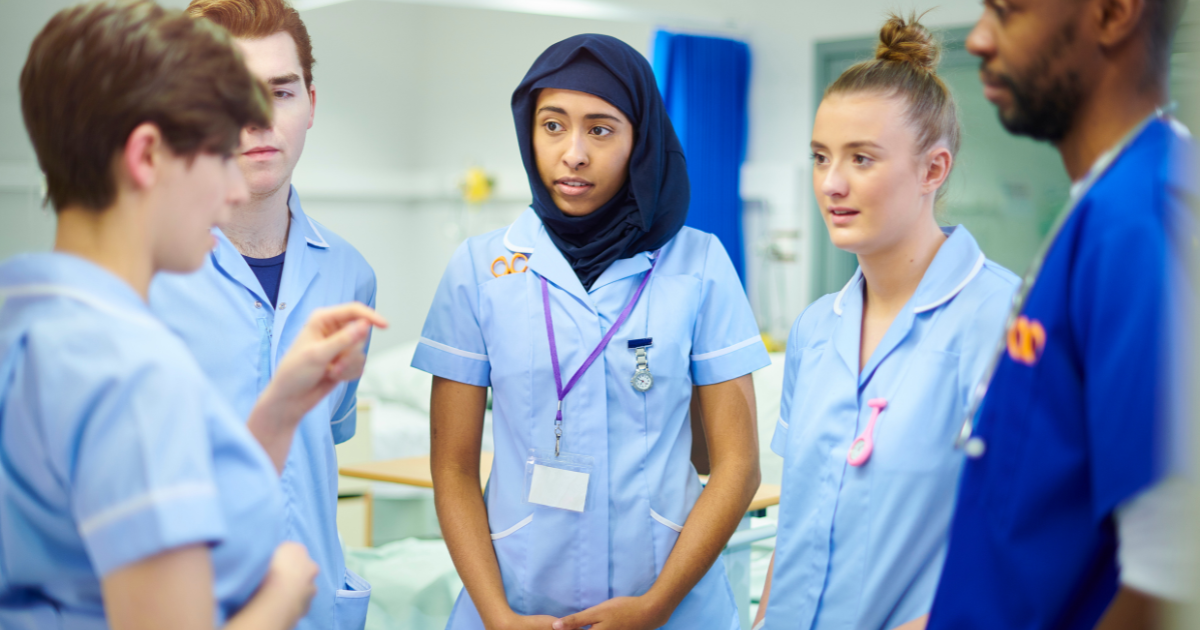 UK nurses discussing wound care best practice and treatment options for hard-to-heal wounds that are not responding to standard care.